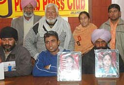 Family members of students, who were either killed or injured in the train-bus collision at Gumtala village on November 23, address mediapersons in Jalandhar on Tuesday.
