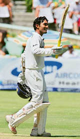 Dinesh Kaarthick celebrates his half century during the first day of the third Test against South Africa in Cape Town on Tuesday.  AFP photo