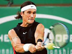 Carlos Moya of Spain in action against German  Alexander Waske during their first round match at the Chennai Open in Chennai on Tuesday. Moya won 7-6, 6-3.  AFP photo