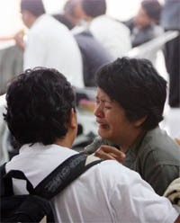 An Indonesian woman weeps for her relative at the Juanda airport in Surabaya on Tuesday.