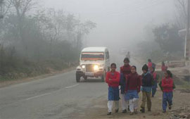 Children going to school at Gurkar village near Manali on Wednesday morning despite dense fog.