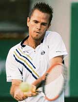 Xavier Malisse of Belgium in action against Stefano Galvani of Italy during their second round match at the Chennai Open in Chennai on Wednesday