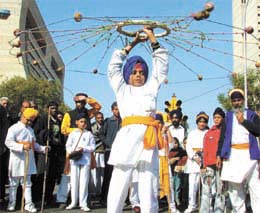A child performing martial arts during a Nagar Kirtan
