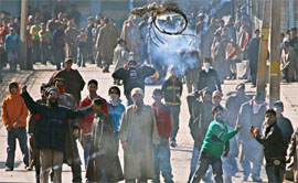 Youth hurl stones on the police in protest against the execution of former Iraqi President Saddam Hussein at Jamia Masjid in downton Srinagar on Thursday.