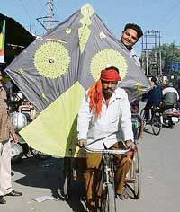 A proud owner of a six-foot kite takes it home in Ludhiana