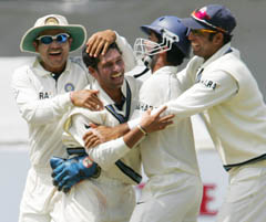 Sachin Tendulkar is congratulated by teammates after dismissing Jacques Kallis on the third day of the third Test in Cape Town on Thursday