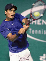 Karan Rastogi plays a return shot to Rafael Nadal of Spain during their second round match in the Chennai Open on Thursday.  Nadal won 6-4, 6-1.  AFP photo