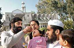 A Health Department worker administers polio drops to a child at Jama Masjid, Sector 20, Chandigarh on Sunday.