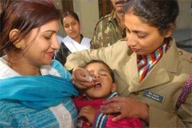 An NCC volunteer administers polio drops to an infant during the drive in Jalandhar on Sunday