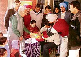 Dr K.C. Goel, District Health Officer, Sangrur, administers polio vaccine to a child at Civil Hospital in Mandi Ahmedgarh