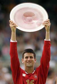Serbias Novak Djokovic holds the trophy after beating Australias Chris Guccione in the final of the Adelaide International tennis tournament on Sunday. 