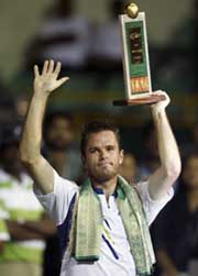 Belgiums Xavier Malisse raises the trophy after beating Austrias Stefan Koubek in the final of the Chennai Open tennis tournament on Sunday. Malisse won 6-1, 6-3