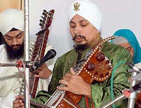 Prof Surinder Singh, Head, Raj Sangeet Academy of Asian Music, UK, performs kirtan using stringed musical instruments at GNI School
