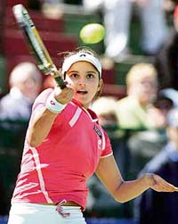 Sania Mirza hits a return during her first-round match against Russias Maria Kirilenko at the Hobart International tennis tournament