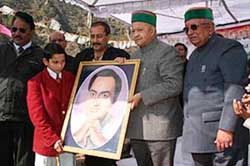 Chief Minister Virbhadra Singh receives a painting presented to him during his visit to the Palampur constituency on Wednesday. 
