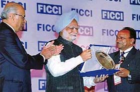 Mr Yashpal Gupta, national secretary of the Bharatiya Vikas Parishad, receives the FICCI award from Prime Minister Manmohan Singh at a function in Delhi