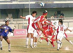 JCTs Baldeep Singh (centre) attempts a header as Mohun Bagans Dharamjit Singh (No. 18) looks on in the 11th National Football League at Ludhianas Guru Nanak Stadium