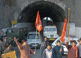 Activists of CITU block traffic during their protest against government policies, in Shimla