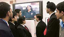 Schoolchildren watch a video recording of Sunita Williams, an American astronaut of Indian origin, at present in International Space Station, at American Center in New Delhi on Wednesday