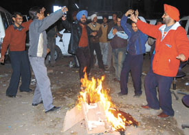 Taxi drivers dancing on the occasion of Lohri, at a taxi stand in Connaught Place in the Capital