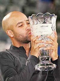 James Blake of the US with the spoils of victory after beating Carlos Moya of Spain in the final at the Sydney International tennis tournament