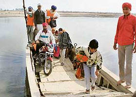 In the absence of a bridge, residents of Muthianwala are forced to use the ferry to reach the mainland.