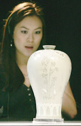 A visitor looks at a Song Dynasty vase at the National Palace Museum, Taipei,