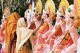 Colourful idols of Saraswati, the Goddess of Learning, stand majestically by the roadside waiting for buyers as Basant Panchami approaches. They definitely would find some buyers but only to be immersed in river waters.