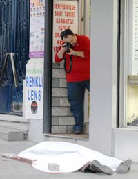 An unidentified man takes a picture of controversial Turkish-Armenian editor Hrant Dink, who was shot dead outside his newspaper office in Istanbul