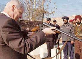 Gerald OConnell, former Chief Officer of the UK Police, inspects a weapon at the Orion School for Security and Intelligence Management, in Mohali on Saturday.