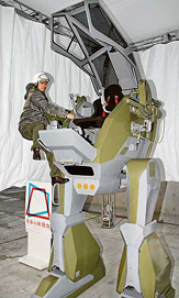 Masaaki Nagumo, an engineer of Japans machinery maker Sakakibara Kikai, gets into a 3.4m tall two-legged robot, Land Walker 01, for a demonstration as part of an exhibition titled, The Power of Expression, Japan, at the newly opened National Art Centre in Tokyo, on Sunday.