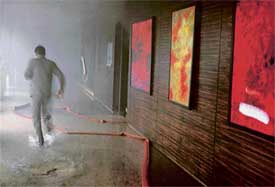 A man runs for his life after fire broke out on the ground floor of Taj Hotel in Sector 17, Chandigarh, on Sunday