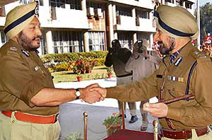 The new DGP of Punjab, Mr R.S. Gill (right), sees off the outgoing DGP, Mr S.S. Virk, at the Punjab Police Headquarters in Chandigarh on Monday.