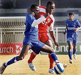 Dempo stopper-back Bolaji Majeck (left) tries to keep the ball in control as JCT striker Edeh Chidi tries to dispossess him in a National Football League match at Ludhianas Guru Nanak Stadium on Monday. 