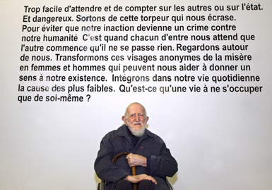 File picture dated February 5,2004, at the "Musee de I'Homme" in Paris showing the abbe Pierre posing under the text of one of his speeches.