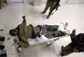 An injured CRPF jawan lies on a stretcher in a hospital in Srinagar 