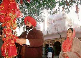 Mr Jagmohan Singh Kang pays obeisance at the Mansa Devi temple before filing his nomination from the Morinda constituency on Tuesday