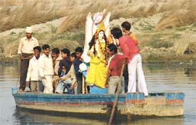 An idol of Goddess Sarasvati being carried by devotees for immersion in the Yamuna in the Capital 