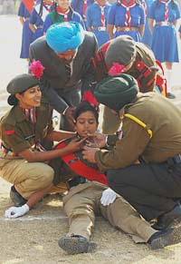 An NCC cadet being revived after she fell unconscious during the Republic Day parade in Jalandhar on Friday.