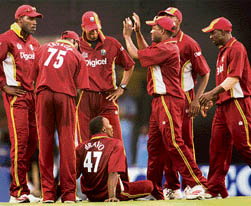 Caribbean players celebrate after restricting India to 268 during the third one-dayer at the MA Chidambaram Stadium in Chennai on Saturday. Dwayne Bravo (sitting) was the wrecker-in-chief with a haul of 4-39 as the West Indies won by three wickets.  PTI photo