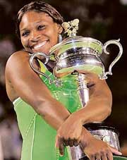 Serena Williams of the USA clutches the trophy after beating Russias Maria Sharapova in the womens singles final at the Australian Open in Melbourne on Saturday. Serena won 6-1, 6-2.