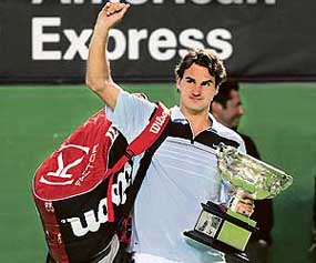Switzerlands Roger Federer holds the trophy after beating Chiles Fernando Gonzalez in the mens singles final at the Australian Open in Melbourne on Sunday. Federer won 7-6, 6-4, 6-4 to clinch his 10th Grand Slam title.