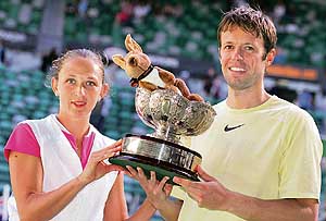Russias Elena Likhovtseva (left) and Canadas Daniel Nestor hold the trophy after winning the mixed doubles final against Max Mirnyi and Victoria Azarenka of Belarus at the Australian Open in Melbourne on Sunday. 