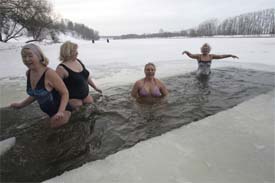 Winter swimmers enjoy icy water in the Moskva river in Moscow on Sunday. Vladimir Grebyonkin, president of the Russian Winter Swimming Federation, says there are between one and two million Russian "morzhy" or walruses. Critics, including many doctors, warn that ice swimming is dangerous. 