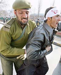The police stops a Shia mourner from taking out the Muharram procession in violation of the ban imposed on it at the Pratap Park, in Srinagar