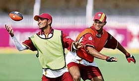 West Indies Denesh Ramdin and Shivnarine Chanderpaul play with a rugby ball during a training session in Vadodara