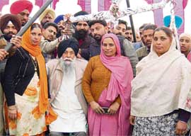 Members of Ravidas Sabha, Mahila Mandal, and panchayat of Devi Nagar village weigh Capt Kanwaljit Singh, the SAD general secretary, against coins during his election campaign on Wednesday. 