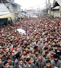 Protesters carry the coffin of Nazir Ahmed, who was allegedly killed by the police last year in a fake encounter, in Srinagar