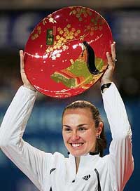 Switzerlands Martina Hingis raises her trophy after beating Serbias Ana Ivanovic 6-4, 6-2 in the final of the Pan Pacific Open tennis tournament in Tokyo on Sunday.