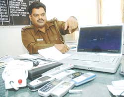 A Delhi Police officer showing the things recovered from the four accused who were arrested for operating a satta racket in the Capital